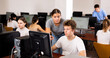 © JackF - Young woman teacher helping concentrated teen male student with his work in college computer class