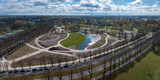 Fototapeta  - New redesigned Victory park in Riga, Latvia with a pond and pedestrian walks.