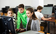 © JackF - Female teacher and her students, young girl and boy, looking at monitor of PC during computer science lesson.