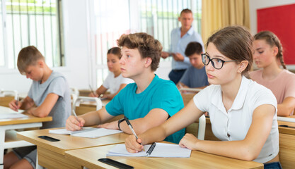 Wall Mural - Student is sitting test and answer about task in the classroom.