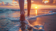 Low Angle View Of Girls Feet Walking On Beach At Sunset