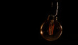 Unlit glass bulb without electricity hanging with warm reflections
