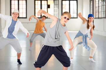 Wall Mural - Team of young dancers training street dance moves and having fun