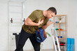 © Pixel-Shot - Sporty young man with bag using inhaler in gym
