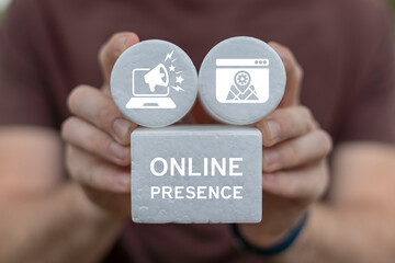 Man holding white blocks with icons sees inscription: ONLINE PRESENCE. Concept of online presence web business marketing technology. Promotion and advertising of products, services on internet.