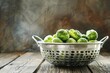 Organic Brussels sprouts in a colander on a table