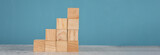 Fototapeta  - wooden block stacking as step stair on blue background. Business concept for growth success process.