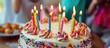 Cake on which brightly colored candles are placed for a birthday