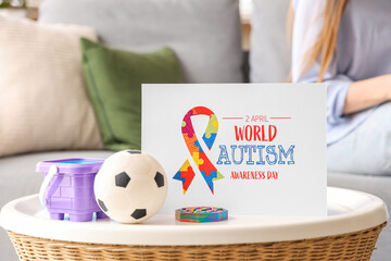 Poster - Paper card with toys on table at child psychologist's office, closeup. World Autism Awareness Day