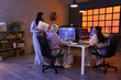 © Pixel-Shot - Group of female programmers working in office at night