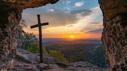 Wall Mural - Sunset view of a wooden cross from a cave