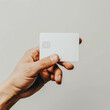 Explore the simplicity of a mockup credit card photo featuring a hand under low key light, set against a clean white background, highlighting modern technology. AI generative.