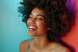 Happy young woman with afro hairstyle against colored background - generative ai