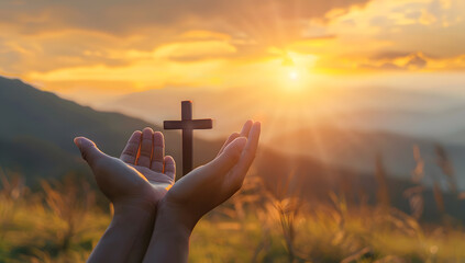 Silhouette of hands presenting Christian cross against sunset