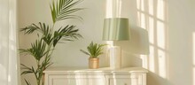 Image Of A White Wooden Cabinet With A Live Plant And Green Lampshade