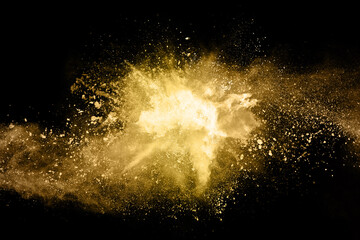 Wall Mural - golden powder explosion on black background. freeze motion.