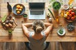 person looking at laptop surrounded with vegetables and fruits , healthy food, healthy lifestyle, wellness	