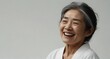 young japanese elderly woman on plain bright white background laughing hysterically looking at camera background banner template ad marketing concept from Generative AI