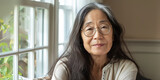 Fototapeta  - portrait of an Asian woman in her fifties with long hair and glasses, generative AI