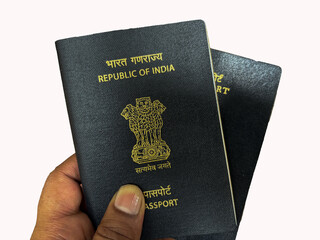 hand holding indian passport in white background