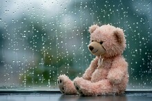 Teddy Bear Sitting On The Windowsill With Raindrops Background
