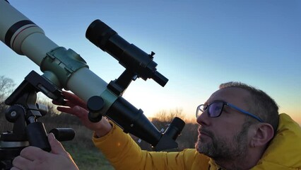 Wall Mural - Amateur astronomer observing skies with a telescope.