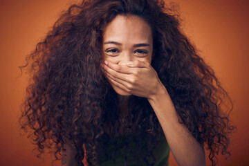 hair, portrait and woman laughing in studio with funny, humor or joke on orange background. haircare
