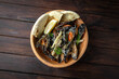 Mussels in sauce on dark boards background. Menu for a pub