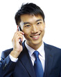 A business Asian man is talking on a cell phone. The file is in PNG format 