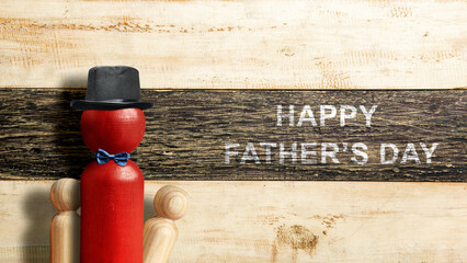 Wall Mural - Red wooden peg doll with a black hat and bow tie with a Happy Father's Day message