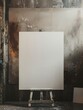 A white canvas on a wooden easel with a white canvas on it