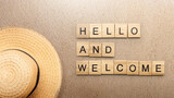 Fototapeta Sawanna - A row of wooden cubes with hello and welcome text