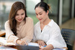 © Wasana - Smiling businesswoman listens attentively during a productive team meeting in a contemporary office setting.