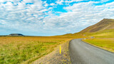 Fototapeta Desenie - Paved Ring road and volcanic crater in Western Iceland, in Autumn colors and blue sky