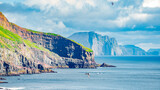 Fototapeta Desenie - Mykines, Faroe Islands. Panoramic view of Mykines island, bird watching destination for puffins. Fjords landscape and seascape with flying puffins