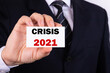 © PRO Balance - A businessman is holding a tablet with the text Crisis 2021 in front of him in his hands. Business concept