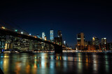 Fototapeta Londyn - The Brooklyn Bridge and Manhattan Financial District seen from Brooklyn Bridge Park at Night - New York City