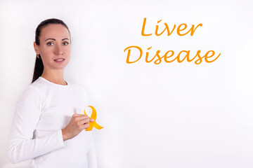 Wall Mural - The yellow ribbon in the doctor's hand is a symbolic color for the Month of Awareness Liver Disease