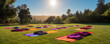 Yoga mats with a towel laid out on a park lawn during sunset, evoking a sense of meditation and rejuvenation