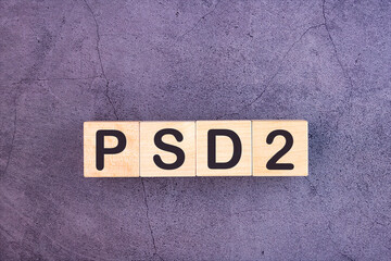 PSD2 acronym from wooden blocks with letters, Payment Service Directive 2 PSD2 online payment and ecommerce concept, top view on grey background