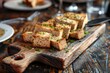 Croutons and liver pate on wooden board in upscale restaurant Background with copy space