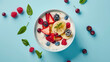 Bowl of yogurt and fruit on a blue background