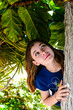 Portrait of a beautiful fashionable teenage girl among the bushes