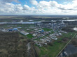 Aerial drone view agricultural industrial installation along the Ghent Terneuzen canal. Processing, distribution and trading of agricultural products. Large industrial facility.