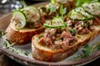 Homemade meat pate on bread with artisan cheese cucumber and herbs