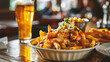 Tasty French fries with meat sauce on wooden table, closeup