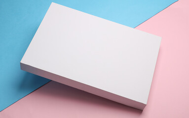 Wall Mural - White cardboard box on blue pink pastel background