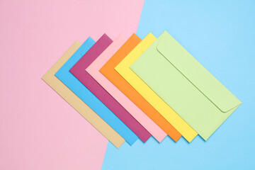 Wall Mural - Set of colored envelopes on a blue-pink pastel background