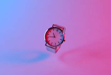 Wall Mural - Floating wristwatch in blue-pink gradient neon light