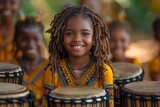 Fototapeta Sport - A group of joyful children in Uganda enjoy learning to play the drums at school.